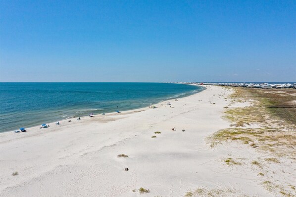 Enjoy a serene beach experience with calm seas and scenic views.