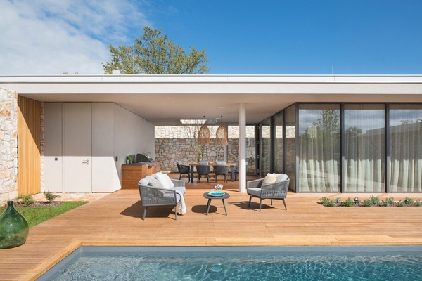 A spacious terrace with a sunbathing area for relaxing next to the large swimming pool of a private family villa Serenity Pula 3 for rent in Istria