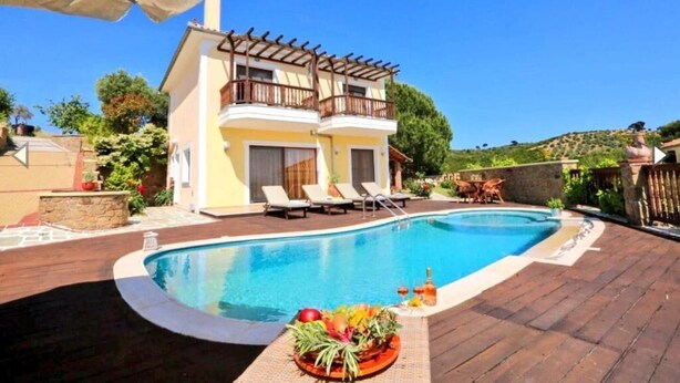 A two-story building with a pool, outdoor furniture, and a pergola. - Luxury Villa Nefeli w Private Pool (Skiathos)