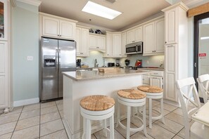 Enjoy cooking in this well-equipped kitchen with a central island and bar stools.