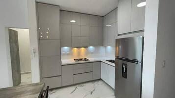 Fridge, microwave, coffee/tea maker, cookware/dishes/utensils