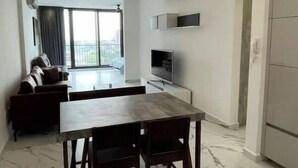 A modern kitchen with a dining area, marble flooring, and a ceiling light fixture. - Dow Town Luxury Loft  (Monterrey)