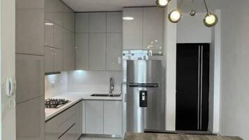 Fridge, microwave, coffee/tea maker, cookware/dishes/utensils