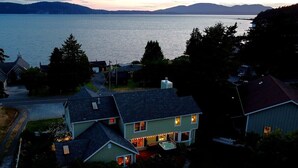 Un quartiere residenziale con case, un vialetto e un ampio specchio d'acqua sullo sfondo.