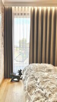 Una habitación con un ventanal grande, una alfombra mullida y un tablero de ajedrez.