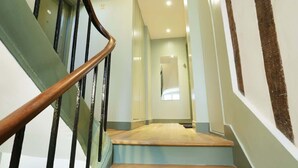 A staircase with wooden handrails and a light-colored floor.