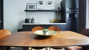 A modern kitchen with a dining area.