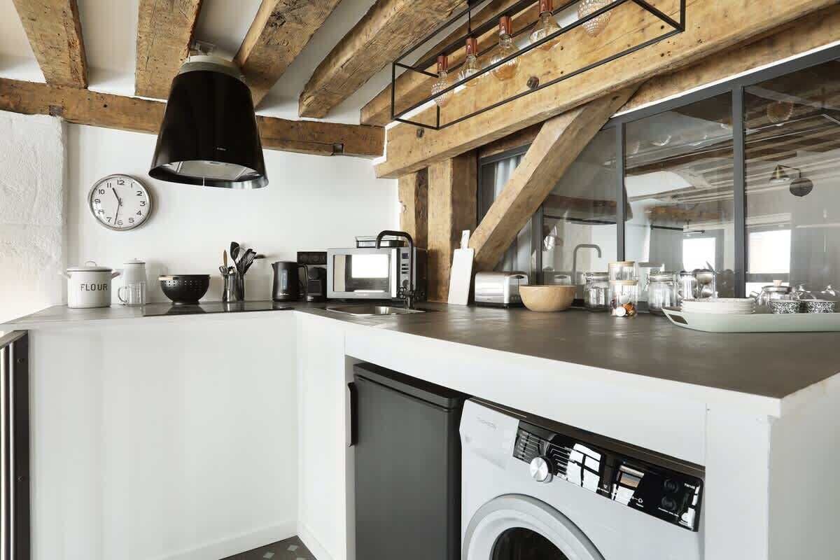 A modern kitchen with a dishwasher, microwave, and coffee maker.