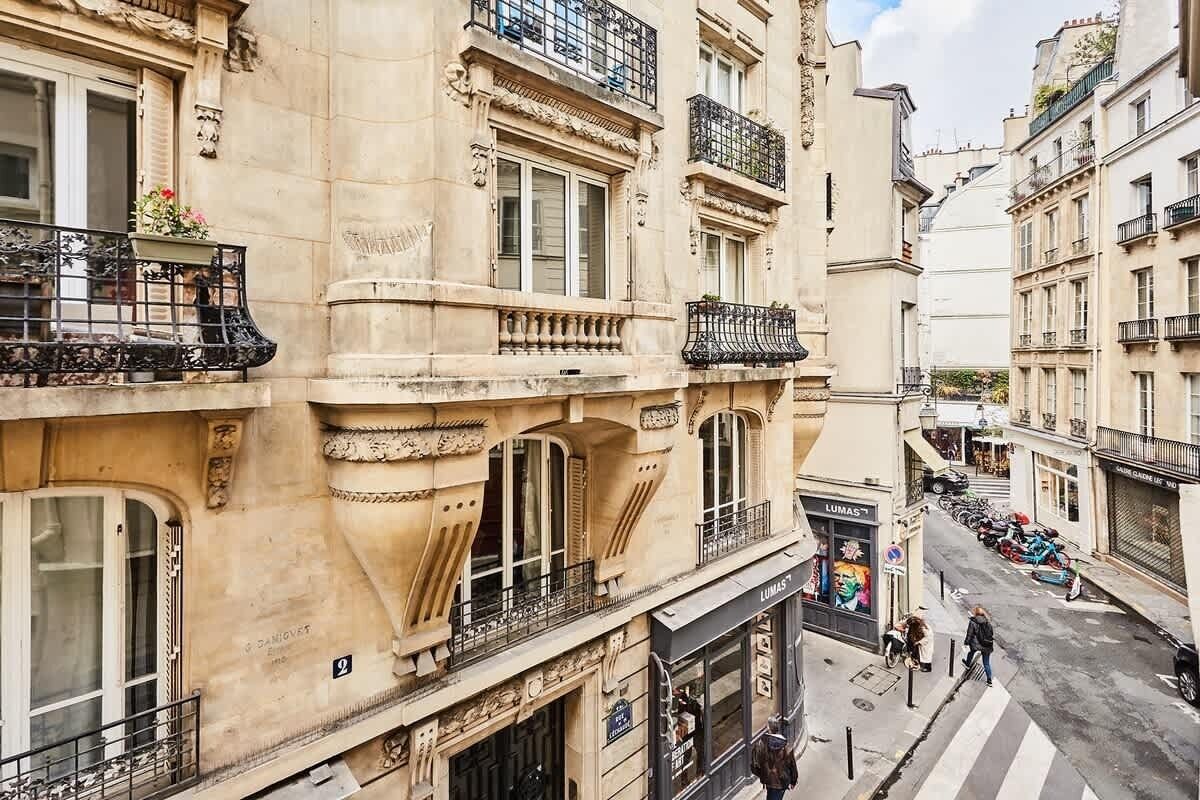 A multi-story building with ornate architectural details, including balconies and large windows.