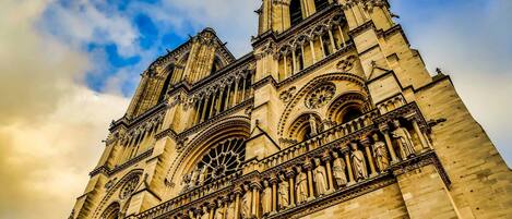 A Gothic cathedral with intricate stone carvings and large rose windows.