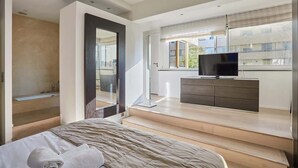 A modern bedroom with a bed, a TV, and a balcony with a view. - Amazing Penthousse Foch/Arc de Triomphe/ Trocadero (Paris)
