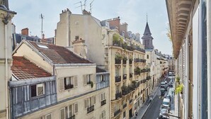 A narrow street lined with multi-story buildings, some with balconies and others with flat facades. - New apartment Center of Paris/Le Marais (Paris)