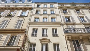 A multi-story building with a classical architectural style, featuring symmetrical windows and balconies with wrought iron railings. - New apartment Center of Paris/Le Marais (Paris)