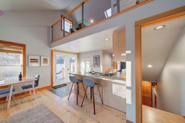 Main level: Stairs descend to Master Bedroom Suite, with doors for privacy.