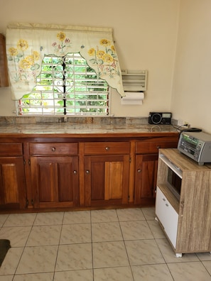 Enjoy cooking in this well-equipped kitchen with a window offering a view.