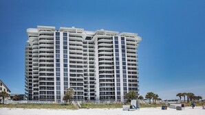 A high-rise hotel with multiple balconies and a beach view. - Watercrest #807 by Resort Collection (Panama City Beach)