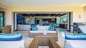 A spacious living area with a central sofa, two armchairs, and a coffee table. - Punta Mita Resort (Punta de Mita)
