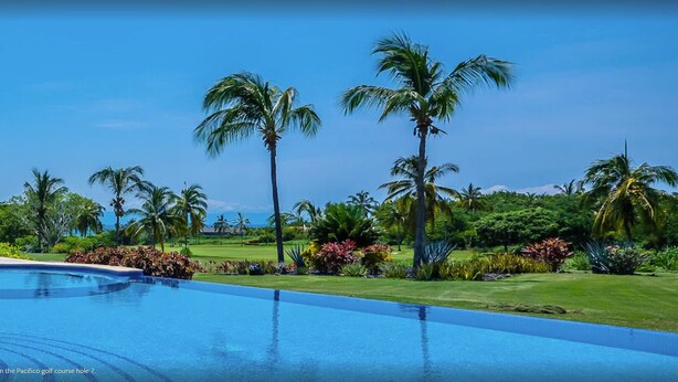 A pool with a clear blue sky and palm trees in the background. - Punta Mita Resort (Punta de Mita)