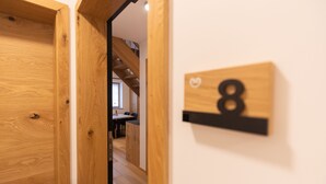 A wooden door leading to a room with a number sign '8' on the wall. - Hotel Vila Loka (Skofja Loka)
