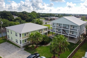 A two-story building with a flat roof, a covered porch, and a parking area. - Top Floor · 3BR 2BA · King Beds · Near Shipyard (Moss Point)