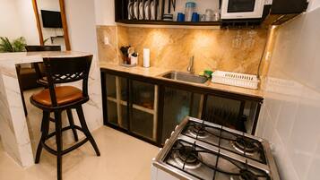 Full-size fridge, microwave, stovetop, rice cooker