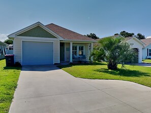 A single-story house with a garage, a covered porch, and a well-maintained lawn. - Sun Kissed Memories by Southern Vacation Rentals (Panama City Beach)