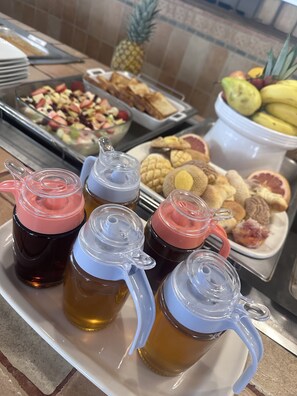 A buffet with various food items and beverages.
