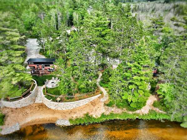 Escape to a serene retreat surrounded by lush greenery and a tranquil pond.