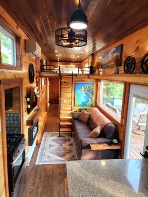Enjoy a loft-style bedroom with a bed and outdoor views from the large window.