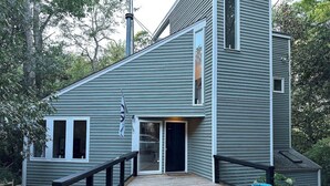 A modern two-story house with a wooden deck and a black railing. - Duke-Rockwood Gem: 2BR/2BA w/ Office & Fenced Yard (Durham)