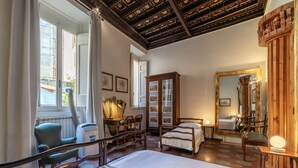 A hotel room with a large bed, a wooden cabinet, a mirror, and a window with curtains. - GuestHost - Pantheon Apartment - The hidden corner of the paintings (Roma)