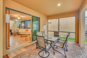 Enjoy a comfortable stay in this inviting space with a glass-top table and sofa set.