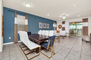 Enjoy meals in this stylish dining area with a dining table, comfortable seating, and a balcony view.