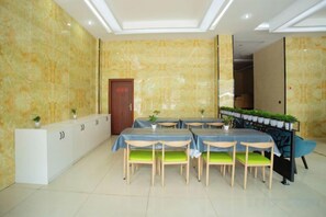 A conference room with a marble wall, a reception desk, and a door. - Xian Biao Business Hotel (Wuping)