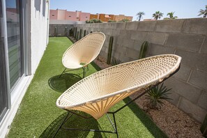 Relax in a serene outdoor space with two comfortable chairs and a tranquil atmosphere.