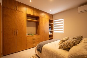 Cozy retreat with a large wardrobe and comfortable bed.