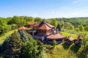 A large estate with multiple buildings, including a main house with a red roof and a smaller structure with a green roof. - Hunting Lodge Hills Retreat, Ribnjačka, Croatia (Ribnjačka)