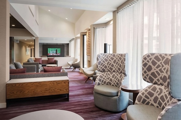 Unwind in the airy lounge with plush seating and soft light.