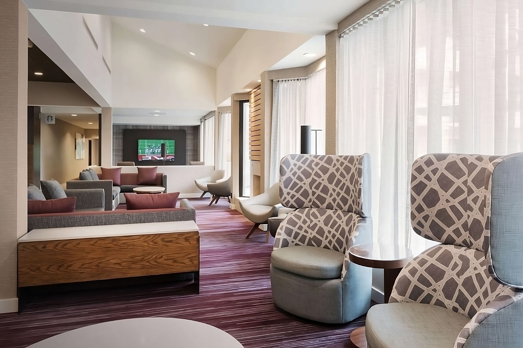 Unwind in the airy lounge with plush seating and soft light.