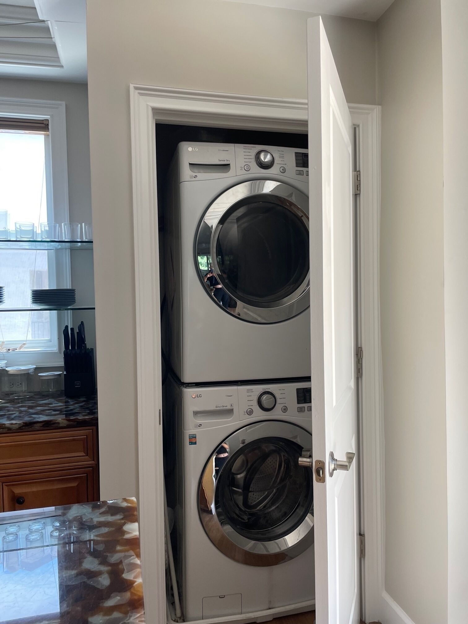 A laundry room with two stacked LG front-loading washers and dryers.