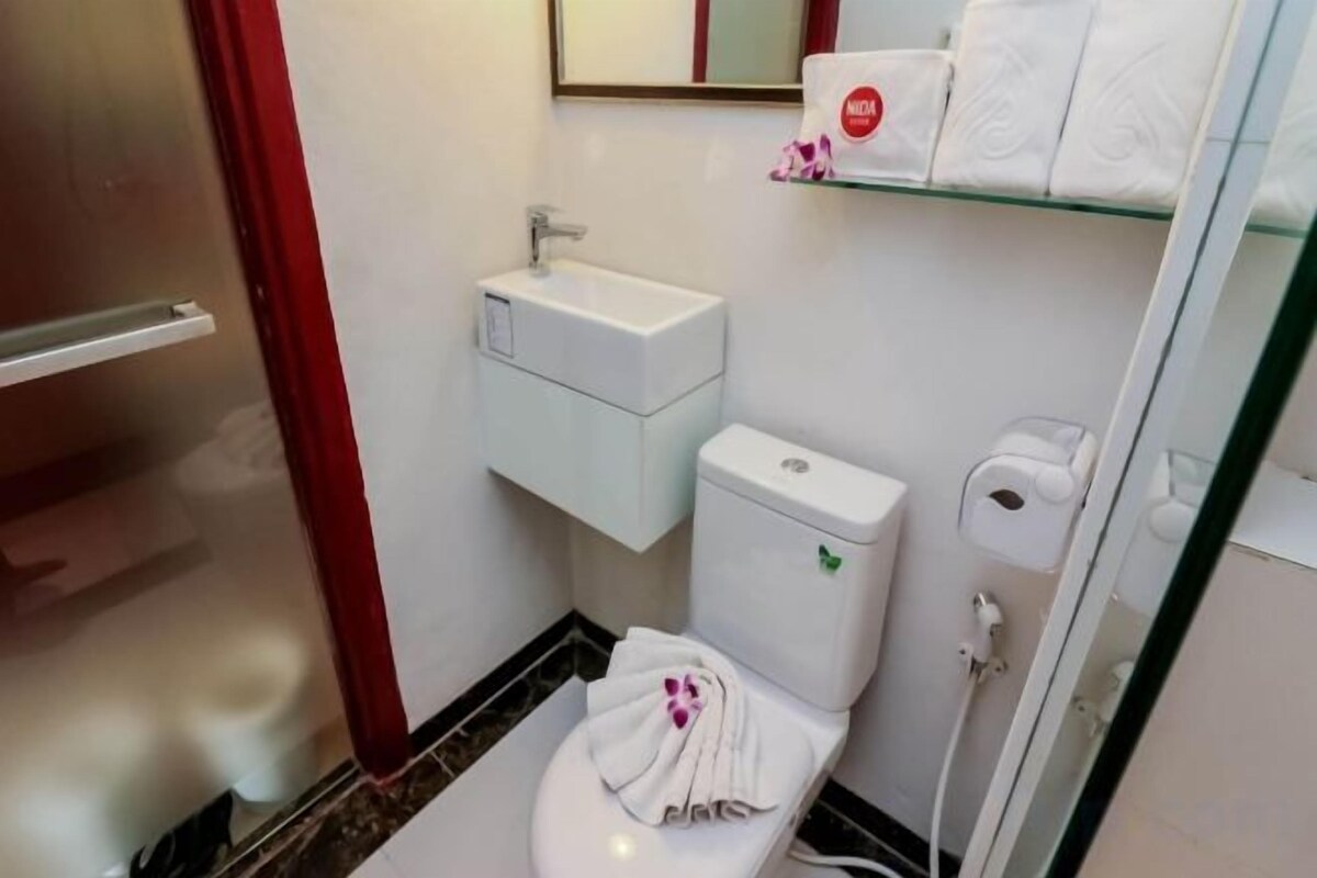 Bathroom | Rainfall showerhead, designer toiletries, hair dryer, slippers