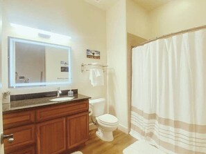 Bathtub, hair dryer, towels, shampoo