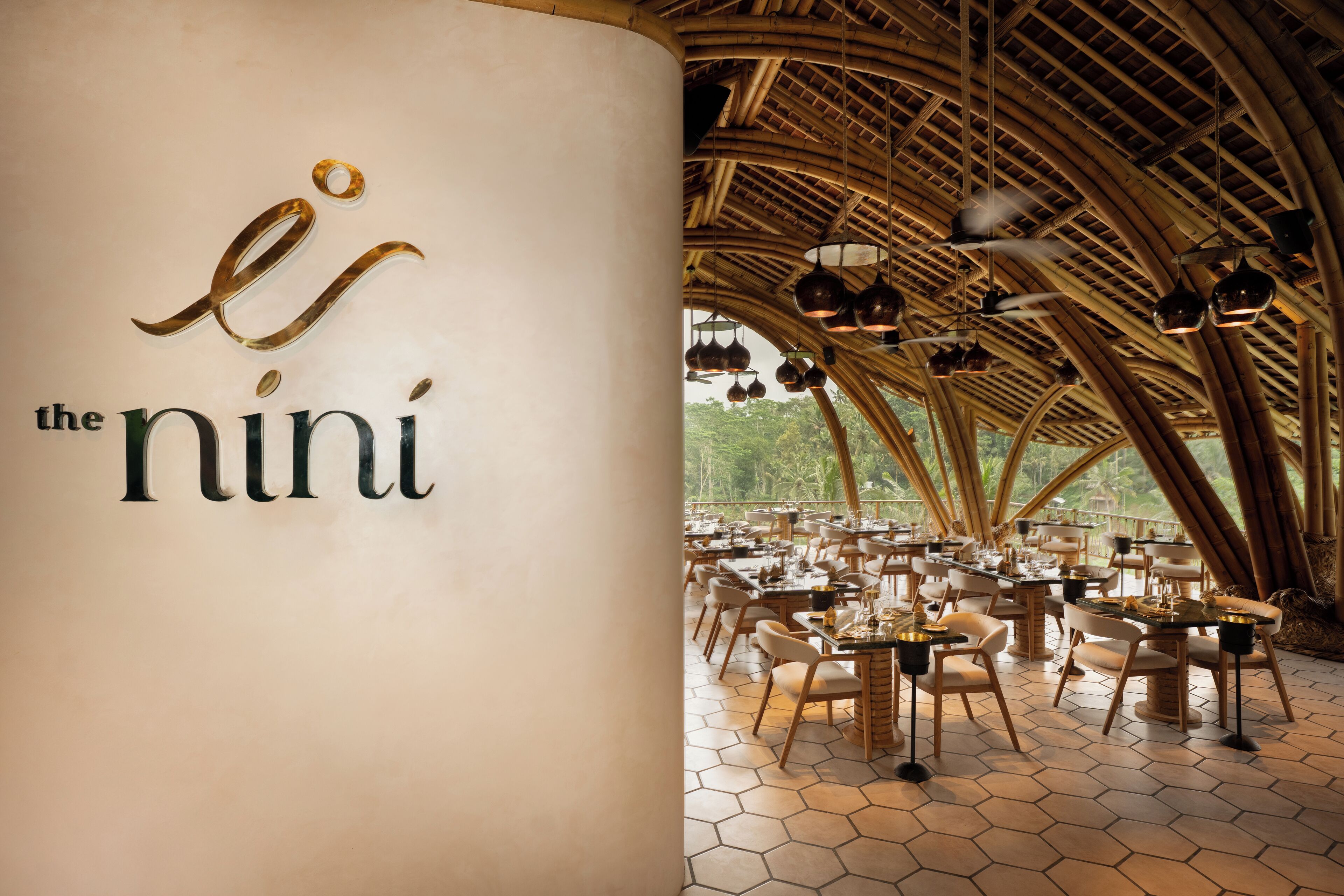 A restaurant with a bamboo ceiling and hexagonal floor tiles.