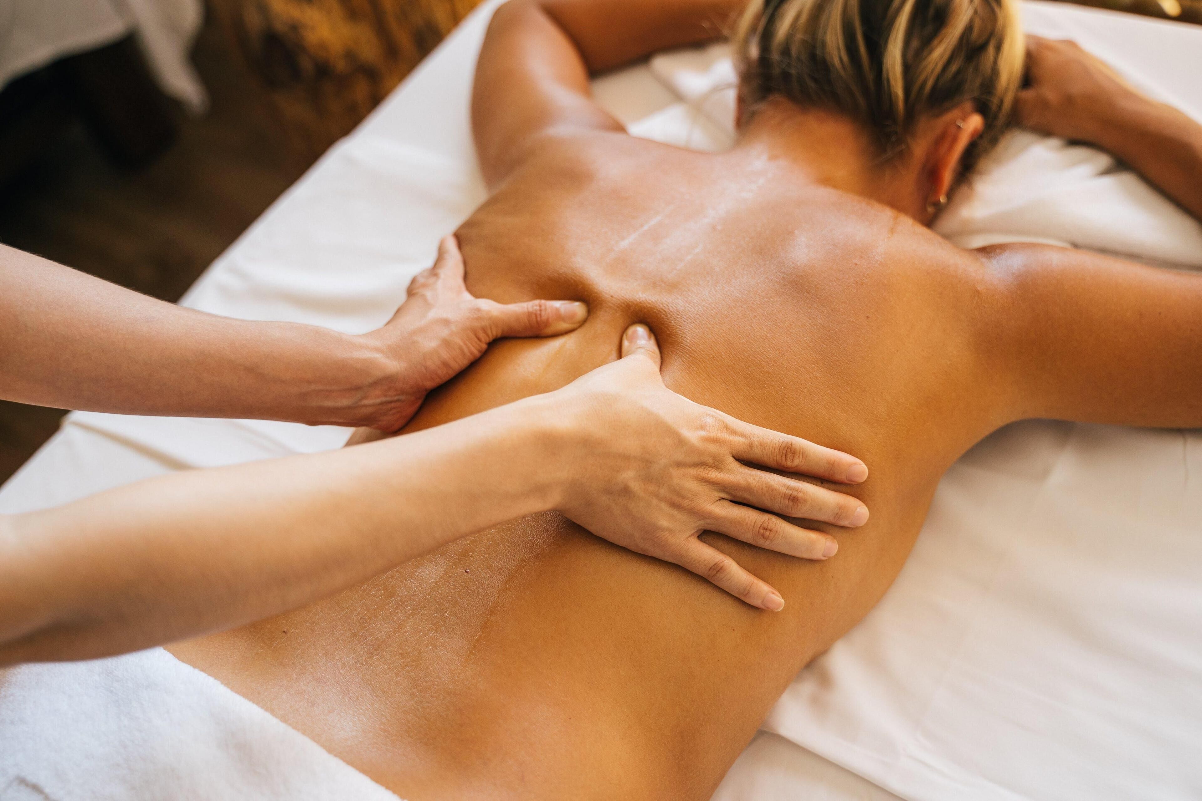 A person receiving a back massage.