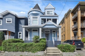 A two-story house with a wrap-around porch, a turret, and a front staircase. - Beatty`s Bohemian Retreat (Pittsburgh)