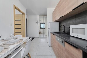 Apartment, 1 Bedroom, Balcony | Private kitchen | Microwave, dishwasher, coffee/tea maker, high chair