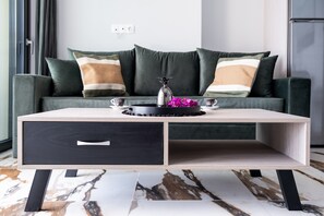 A modern living room with a sofa, a coffee table, and a decorative vase.
