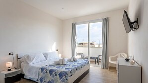 A bedroom with a bed, bedside table, lamp, and a view of the outside. - Holiday Home "Sefy Mare a Selinunte" with Sea View, Balcony & Wi-Fi (Marinella)