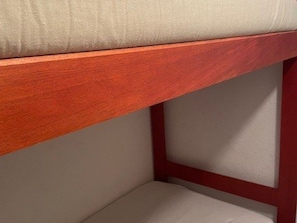 A bunk bed with a wooden frame and a beige mattress. - Seaside Apartment with Pool, A/C, and Garage - Sleeps 6, Port Camargue (Port Camargue)