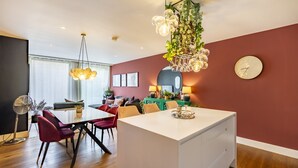 A modern dining area with a central island, a fan, and a clock on the wall. - 3Ten @ Ryedale House -  a premium stay that sleeps 4 guests  in 2 bedrooms (York)